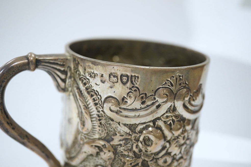 A late Victorian demi- wrythened fluted and embossed christening mug, by Josiah Williams & Co, London, 1892, 94mm, 4.6oz. Condition - poor to fair